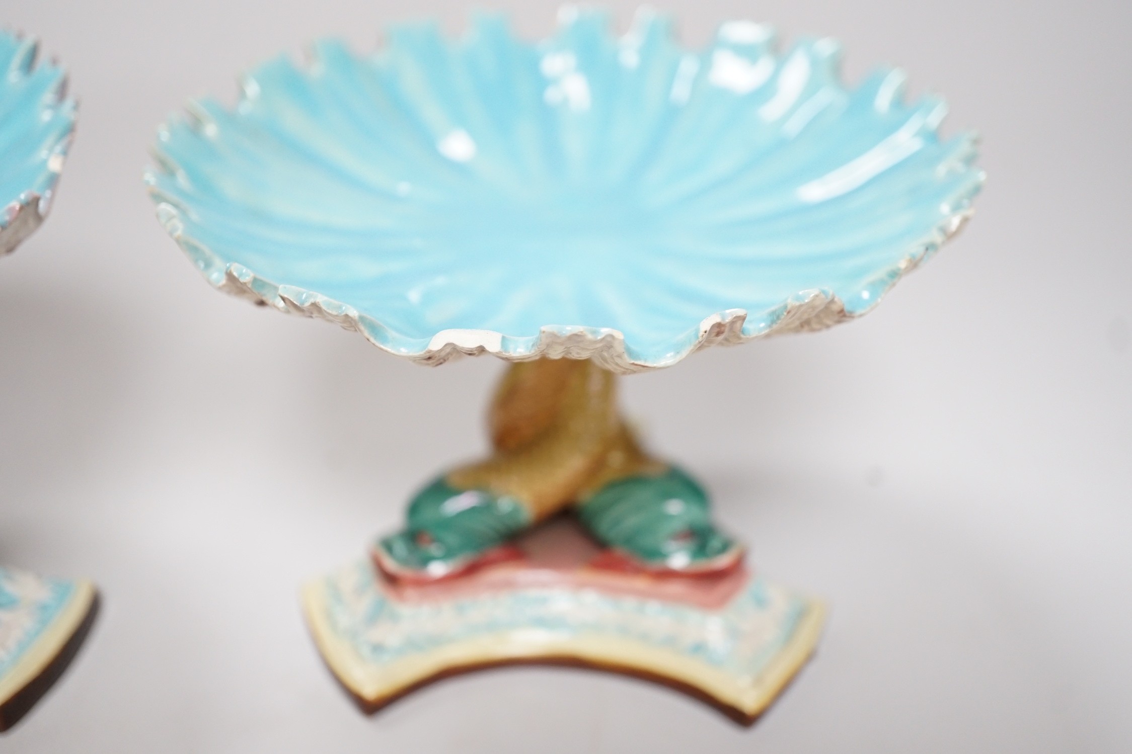 A pair of late 19th century Royal Worcester majolica dolphin comports, 10cm tall